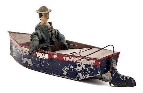 * A Painted Tin "Boatman" Toy Length overall 11 inches.