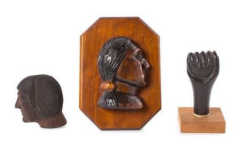 Manly L. Lundberg, (American, 1908-1973), a set of two carved profiles and a carved fist