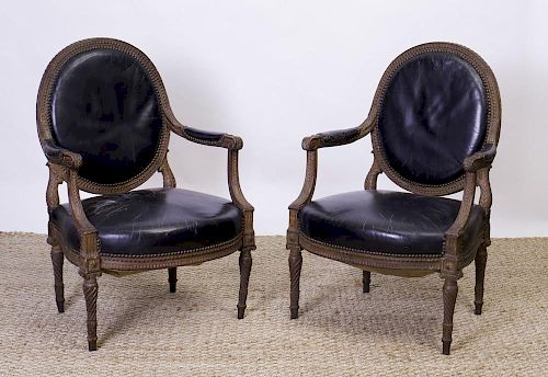 PAIR OF LOUIS XVI STYLE STAINED BEECHWOOD AND LEATHER UPHOLSTERED FAUTEUILS À LA REINE