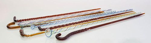 GROUP OF NINE AMBER AND INTERNALLY-DECORATED GLASS CANES