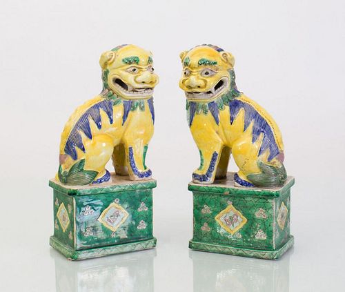 PAIR OF CHINESE YELLOW, GREEN AND BLUE GLAZED BUDDHISTIC LIONS