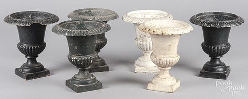 Six small cast iron urns