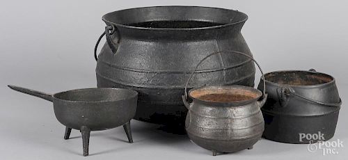 Three iron pots, together with a skillet
