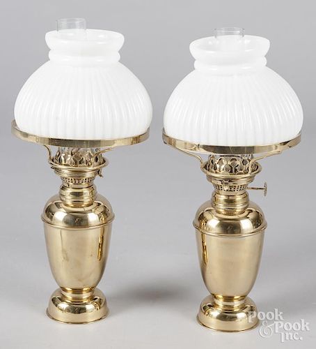 Pair of gimbaled brass fluid lamps, together with a single lamp