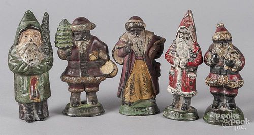Five painted cast iron Santa Claus paperweights