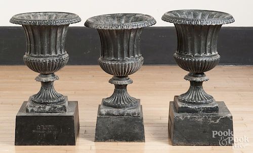 Three J.W. Fiske cast iron garden urns