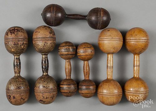 Seven wooden dumbbells.