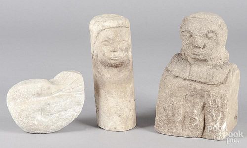 Three carved stone figures