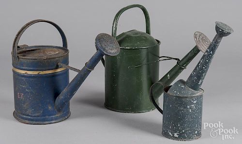 Three painted watering cans
