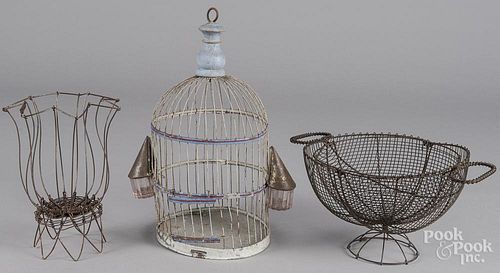 Two wire baskets, together with a birdcage
