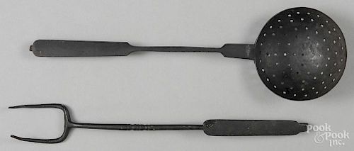 Two candlemolds, together with a fork and ladle