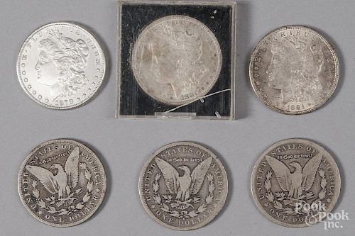 Six Morgan silver dollars.