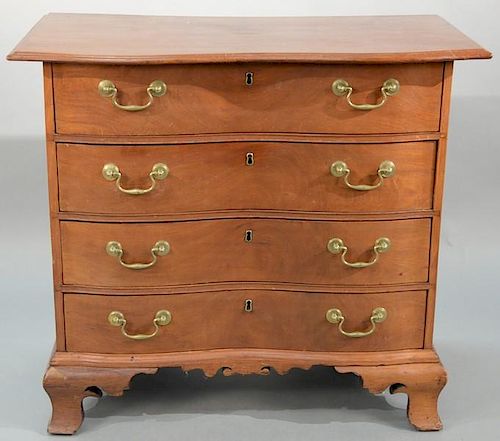 Chippendale mahogany oxbow chest having shaped overhanging top over four oxbow drawers on carved apron and large ogee carved