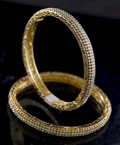Matched pair of 18k yellow gold and diamond bracelets