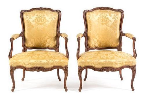 A Pair of Louis XV Style Walnut Fauteuils Height 36 inches.