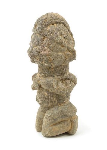 * An African Kissi Stone Kneeling Figure Height 11 1/4 inches.