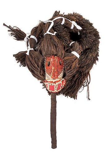 * A Senufo Wood and Raffia Mask and Costume Length overall 102 inches.