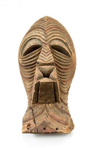 * A Kifwebe Carved and Painted Wood Mask Height 20 1/2 inches.