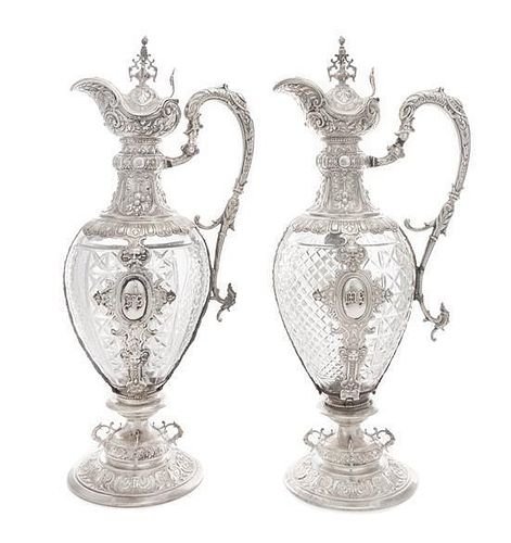 A Pair of Continental Silver Mounted Cut Glass Claret Jugs, Likely German, 19th Century, each having an urn finial above the 