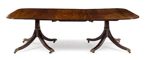 A George III Mahogany Twin-Pedestal Extension Dining Table Height 28 x width 70 (closed) x depth 48 inches.