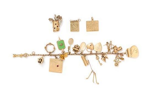 A 14 Karat Yellow Gold Bracelet with 18 Attached and Unattached Charms, 55.20 dwts.