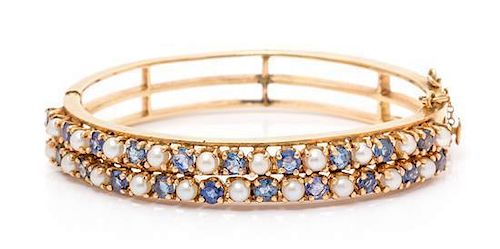 * A 14 Karat Yellow Gold, Sapphire and Cultured Pearl Bangle Bracelet, 21.10 dwts.