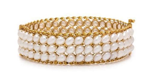 A Yellow Gold and Cultured Pearl Bangle Bracelet, 24.50 dwts.