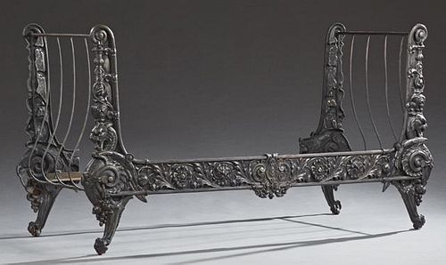 Cast Iron Continental Style Daybed, 20th c., the sleigh ends with relief floral and lion head decoration, joined by curved sp