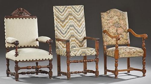 Group of Three French Louis XIII Style Fauteuils, early 20th c., consisting of an oak example with an arched crest and floret