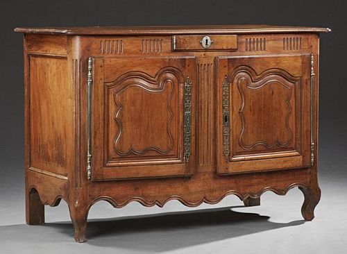French Provincial Louis XV Style Carved Walnut Sideboard, mid 19th c., the ogee edge rounded corner top over a central frieze