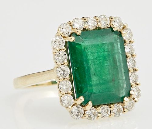 Lady's 18K Yellow Gold Dinner Ring, with an 8.22 carat emerald atop a border of round diamonds, total diamond weight- 1.5 cts