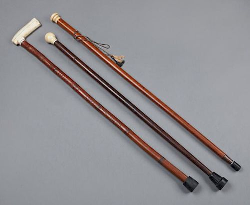 Group of Three Carved Whale Bone Wood Canes, 19th c., one with an incise carved shaft and a bone L-shaped handle; one of rose