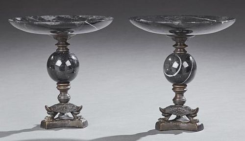Pair of Black Marble and Bronze Compotes, 20th c., the figured black marble tops on bronze socle supports on a black marble o