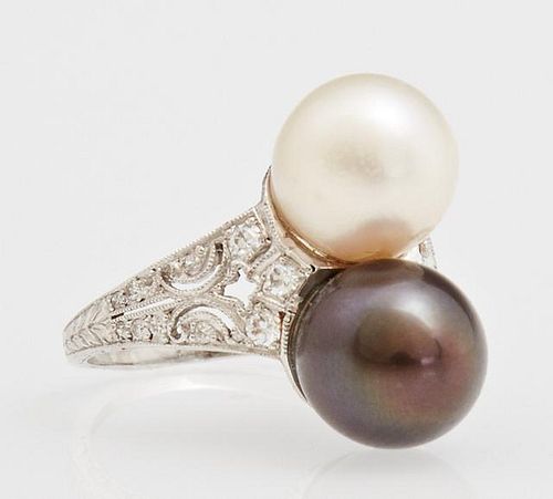 Lady's 18K White Gold Dinner Ring, with 9 mm white and black pearls, flanked by a tapering pierced band mounted with small ro