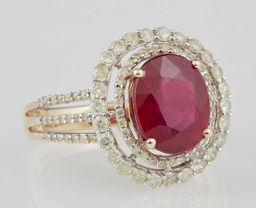 Lady's 14K Yellow Gold Dinner Ring, with an oval 3.96 carat ruby atop a border of small round diamonds and a pierced concentr