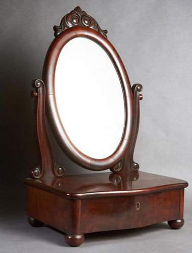 American Carved Mahogany Shaving Mirror, late 19th c., the oval mirror with a scrolled surmount, on curved reeded supports to