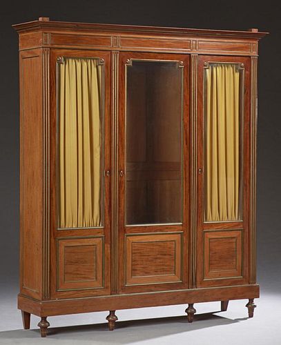 French Louis XVI Style Carved Mahogany Ormolu Mounted Armoire, 19th c., the stepped top with turned finials, above a paneled 