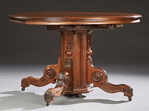 American Victorian Carved Mahogany Circular Dining Table, late 19th c., the stepped top to an octagonal support on quadruped 