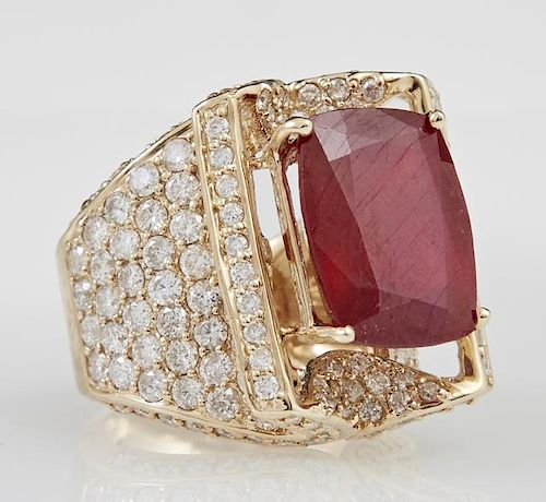 Lady's 14K Yellow Gold Dinner Ring, with a 14.85 carat cushion cut ruby within a stylized lifted diamond mounted gallery flan