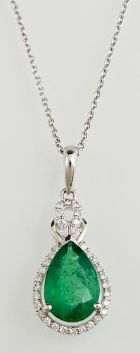 Platinum Pendant, with a pear shaped 2.2 carat emerald atop a border of tiny round diamonds, beneath an integral diamond moun