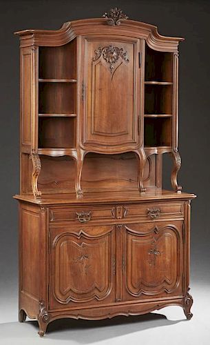 French Louis XV Style Carved Walnut Buffet a Deux Corps, late 19th c., the stepped arched crown over a central fielded panel 