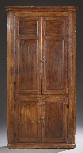 English Carved Oak Corner Cabinet, 19th c., the stepped ogee crown over double two panel doors, above lower double cupboard d