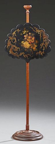 English Black Lacquer and Mahogany Pole Screen, 19th c., the scalloped adjustable lacquer screen with a scrolled gilt border 