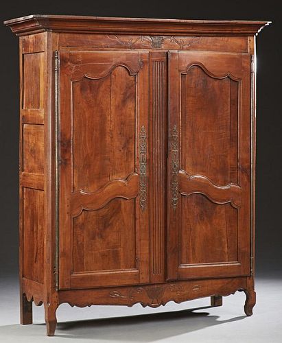 French Louis XV Style Carved Cherry Armoire, 19th c., the stepped canted corner ogee crown over double cupboard doors with lo