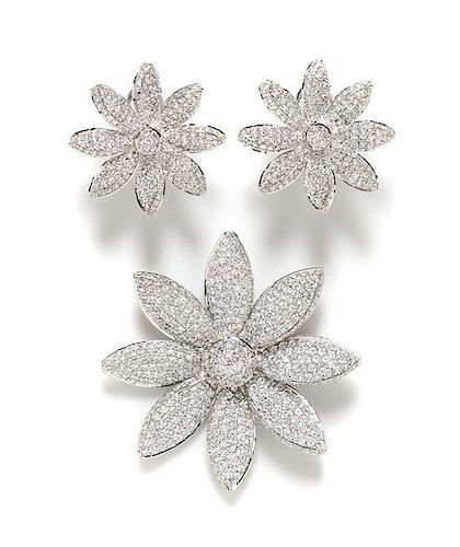 A Sterling Silver Rhinestone Floral Demi Parure, Brooch: 2.25" circumference; Earclip: 1.25".