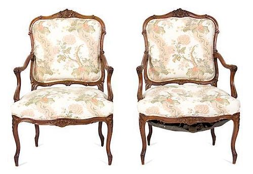 A Pair of Louis XV Style Carved Walnut Fauteuils a La Reine Height 46 1/2 x width 27 x depth 23 inches.