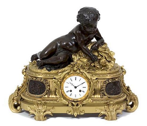 A Louis XV Style Ormolu and Patinated Bronze Mantel Clock Height 20 x width 25 1/2 x depth 9 1/2 inches.