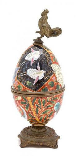 A Continental Polychromed Porcelain Gilt Metal Mounted Egg-Form Box Height 8 1/4 inches.