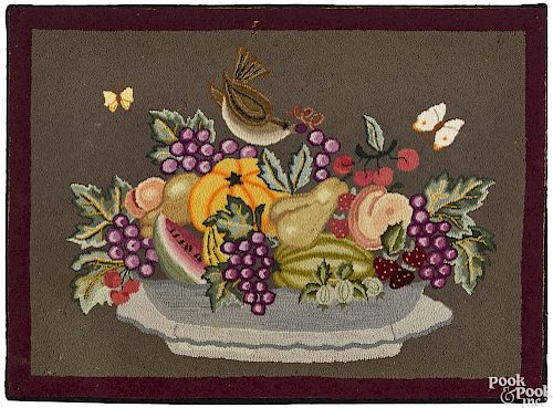 American hooked rug with bowl of fruit