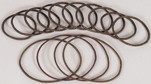 A GROUP OF TEN BRASS AND COPPER BANGLES